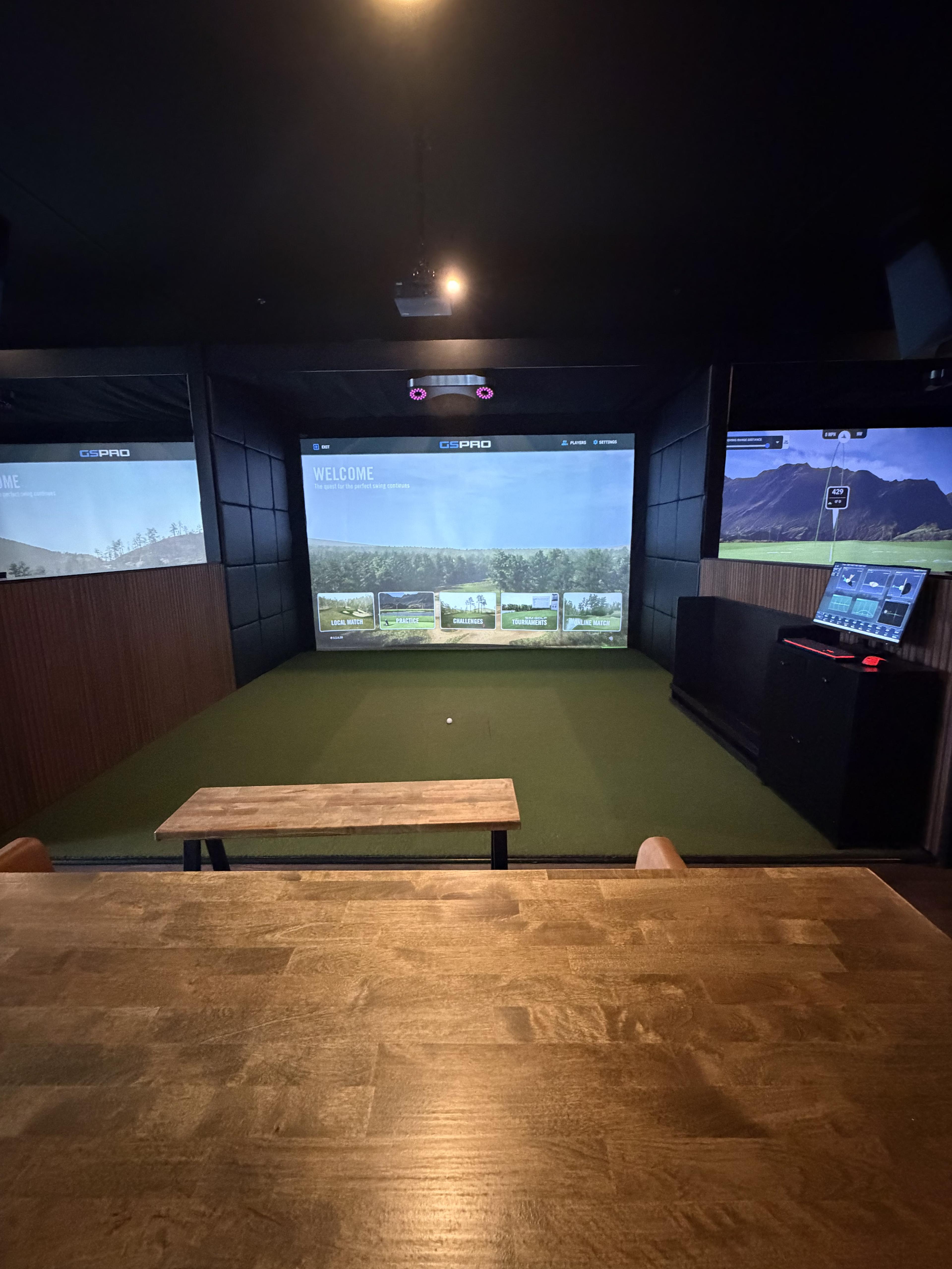 A simulator bay at Albatross Golf Lounge.